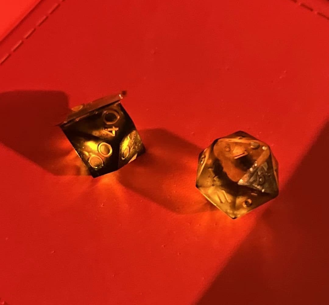 Two glowing dice on a red dice tray