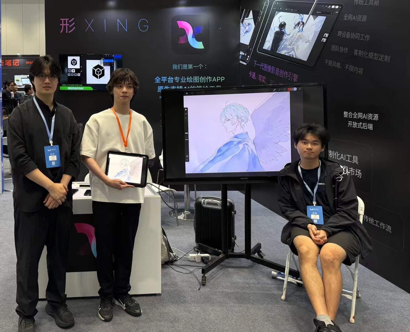 XING Art booth at trade show — three young men with iPad showing in-progress anime drawing